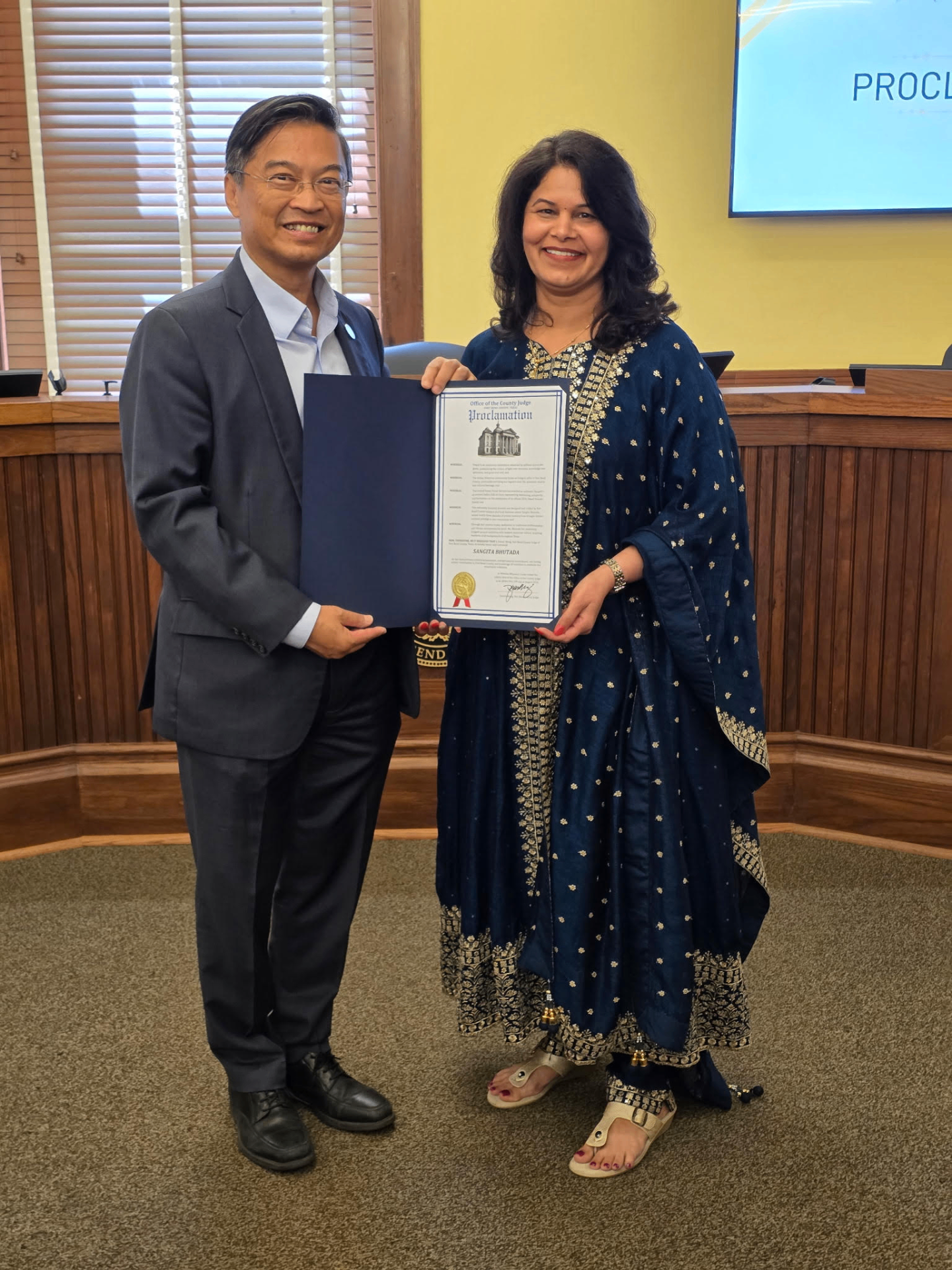 Sangita Bhutada receiving the official Proclamation from Fort Bend County Judge Daniel Wong